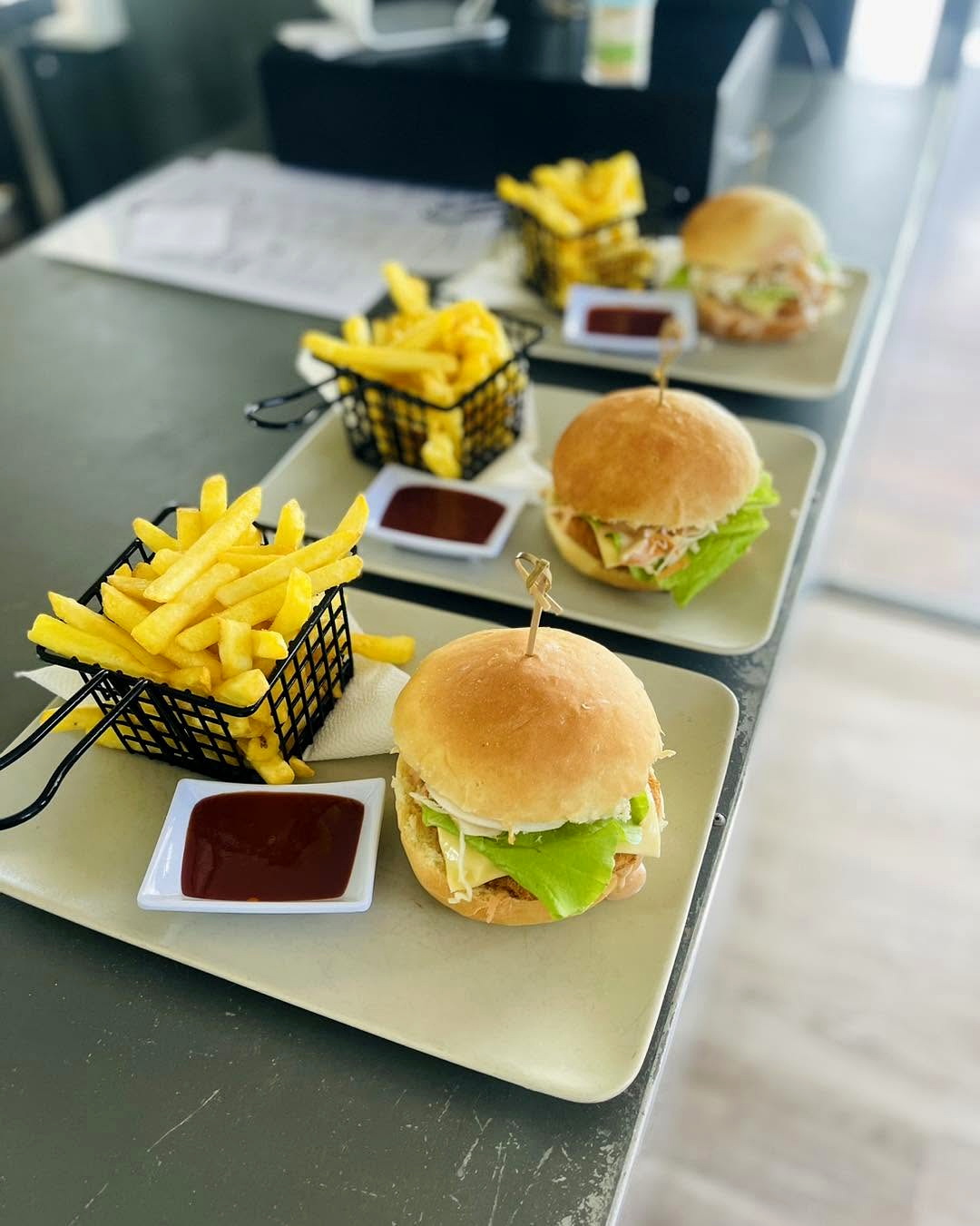Burgers and chips served on plates